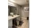 This bathroom features a double vanity, a tiled floor, and modern fixtures at 2626 Summit Sw Pkwy, Atlanta, GA 30331