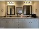 Bright bathroom featuring a double vanity, granite countertop, and framed mirrors with decorative lighting at 101 Elkins Blvd # 53, Locust Grove, GA 30248