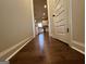 Hallway with hardwood floors and views to the kitchen at 101 Elkins Blvd # 53, Locust Grove, GA 30248