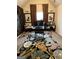Cozy home office features a unique accent wall, neutral carpet, and decorative rug at 101 Elkins Blvd # 53, Locust Grove, GA 30248