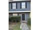 Charming two-story townhome with a gray exterior, black shutters, and a neatly landscaped entrance at 8547 Jamestown Way, Jonesboro, GA 30238