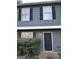Well-maintained townhome featuring a gray exterior with contrasting black shutters and a neat front yard at 8547 Jamestown Way, Jonesboro, GA 30238