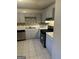 A well-lit kitchen features gray cabinets and stainless steel appliances, offering a modern culinary space at 8547 Jamestown Way, Jonesboro, GA 30238