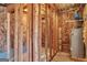 A view of an unfinished basement showcasing wooden beams, insulation, and the home's water heater system at 1515 Summer Lake Ter, Loganville, GA 30052