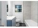 Stylish bathroom showcases a blue vanity, gray tiles, and shower at 1894 Evans Evans Sw Dr, Atlanta, GA 30310