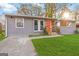 The inviting home has an orange door, gray siding, and a bright green lawn at 1894 Evans Evans Sw Dr, Atlanta, GA 30310