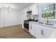 Modern kitchen featuring stainless steel appliances, white cabinets, and a stylish tile backsplash at 1894 Evans Evans Sw Dr, Atlanta, GA 30310