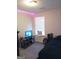 Cozy bedroom featuring carpeted floors, a window, and neutral wall color at 7236 Georges Way, Morrow, GA 30260