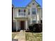 Charming townhome featuring a private balcony and a welcoming front entrance at 7236 Georges Way, Morrow, GA 30260