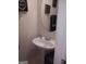 Compact powder room featuring a pedestal sink and decorative wall art at 7236 Georges Way, Morrow, GA 30260