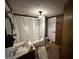 Bathroom with a shower-tub combo and pedestal sink at 45 Poplar St, Porterdale, GA 30014