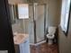 Bathroom featuring a stand-up shower, toilet, vanity with sink, mirror, and brown tile floor at 5549 Highway 42, Ellenwood, GA 30294