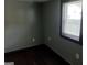 Bedroom with gray walls, black trim, dark flooring, and a window with blinds at 5549 Highway 42, Ellenwood, GA 30294