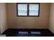 Bedroom with light colored walls, dark trim, and window with blinds at 5549 Highway 42, Ellenwood, GA 30294