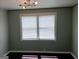 Bedroom with light green walls, dark flooring, and a vintage light fixture at 5549 Highway 42, Ellenwood, GA 30294