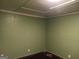 Empty room with light green walls, dark trim, and dark hardwood floors at 5549 Highway 42, Ellenwood, GA 30294