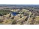 Expansive aerial view showcasing the estate with a serene pond and surrounding lush landscape at 105 Coogler Way, Brooks, GA 30205