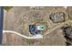 Aerial view features a modern home design, solar panels, and a private pool surrounded by ample land at 105 Coogler Way, Brooks, GA 30205