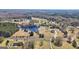 An impressive aerial perspective of the property features a tranquil pond and verdant surroundings at 105 Coogler Way, Brooks, GA 30205