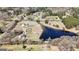 An impressive aerial perspective shows the expansive grounds with a pond, outbuildings, and serene landscape at 105 Coogler Way, Brooks, GA 30205
