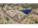 An expansive aerial view captures the estate's layout with a pool, pond, and various outbuildings at 105 Coogler Way, Brooks, GA 30205