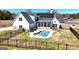 An aerial view of the backyard with in-ground pool and covered patio at 105 Coogler Way, Brooks, GA 30205