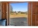 View from inside barn, of the house, pasture, and red barn, capturing the essence of country living at 105 Coogler Way, Brooks, GA 30205
