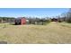 Large grassy area with a barn and sheds at 105 Coogler Way, Brooks, GA 30205
