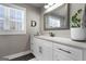 Well-lit bathroom featuring white vanity, modern fixtures, and a large mirror, offering style and functionality at 105 Coogler Way, Brooks, GA 30205