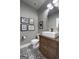 Stylish powder room features patterned tile floor, floating sink with modern fixtures, and framed art at 105 Coogler Way, Brooks, GA 30205