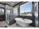 Charming bathroom featuring a clawfoot tub, tiled shower, and a bright window at 105 Coogler Way, Brooks, GA 30205