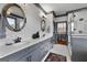 Updated bathroom with double vanity, walk-in shower, and stylish floral wallpaper at 105 Coogler Way, Brooks, GA 30205