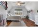 Bright bedroom with hardwood floors, ceiling fan, and hanging hammock, designed for comfort and style at 105 Coogler Way, Brooks, GA 30205