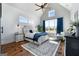 Bright bedroom with high ceilings, hardwood floors, and a cozy sitting area by a large window at 105 Coogler Way, Brooks, GA 30205
