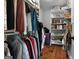 Walk-in closet with custom white shelving, hanging rods, shoe racks and wood flooring at 105 Coogler Way, Brooks, GA 30205