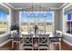A dining room with a large window, modern light fixture, and a wooden table with seating for six at 105 Coogler Way, Brooks, GA 30205