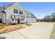 Beautiful farmhouse-style home featuring a long driveway, three-car garage, and a large yard at 105 Coogler Way, Brooks, GA 30205