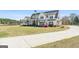 Beautiful two-story home with a long driveway and well-maintained front yard and landscaping at 105 Coogler Way, Brooks, GA 30205