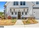 Charming home entrance with brick accents, wood door, covered porch, and manicured landscaping at 105 Coogler Way, Brooks, GA 30205