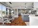 Open concept kitchen and dining area with stylish lighting, white cabinetry, and hardwood flooring at 105 Coogler Way, Brooks, GA 30205