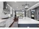 A kitchen with white cabinets and quartz countertops, flowing into an eat-in area with lots of natural light at 105 Coogler Way, Brooks, GA 30205