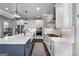 Modern kitchen with a central island, stainless steel appliances, white cabinetry and wood flooring at 105 Coogler Way, Brooks, GA 30205