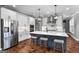 A kitchen with stainless steel appliances, an island with seating, and modern lighting fixtures at 105 Coogler Way, Brooks, GA 30205