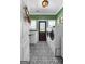 Modern laundry room with patterned tile floor, white cabinetry, and updated washer/dryer at 105 Coogler Way, Brooks, GA 30205