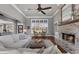 Bright living room featuring a brick fireplace, high ceilings, hardwood floors, and large window overlooking the front yard at 105 Coogler Way, Brooks, GA 30205