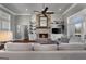 Comfortable living room with a brick fireplace, built-in shelving, and stylish seating at 105 Coogler Way, Brooks, GA 30205