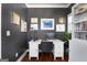 A cozy office with a white desk, dark accent wall, and built-in shelving for books and decor at 105 Coogler Way, Brooks, GA 30205