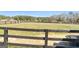 Black-fence paddock with a water trough for livestock and a peaceful, rural setting at 105 Coogler Way, Brooks, GA 30205