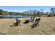 Picturesque view of a peaceful pond with seating area and fire pit, ideal for relaxing or entertaining at 105 Coogler Way, Brooks, GA 30205
