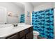 Bathroom featuring a vanity with modern fixtures and a blue patterned shower curtain at 243 Summergate Ln, Villa Rica, GA 30180